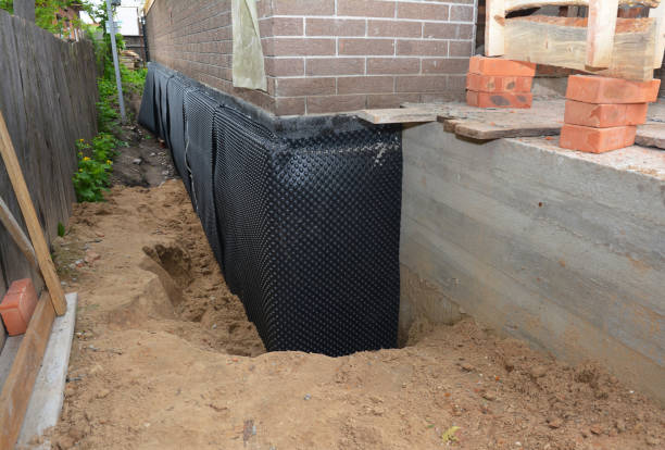 Happy homeowners after waterproofing job in Blue Point